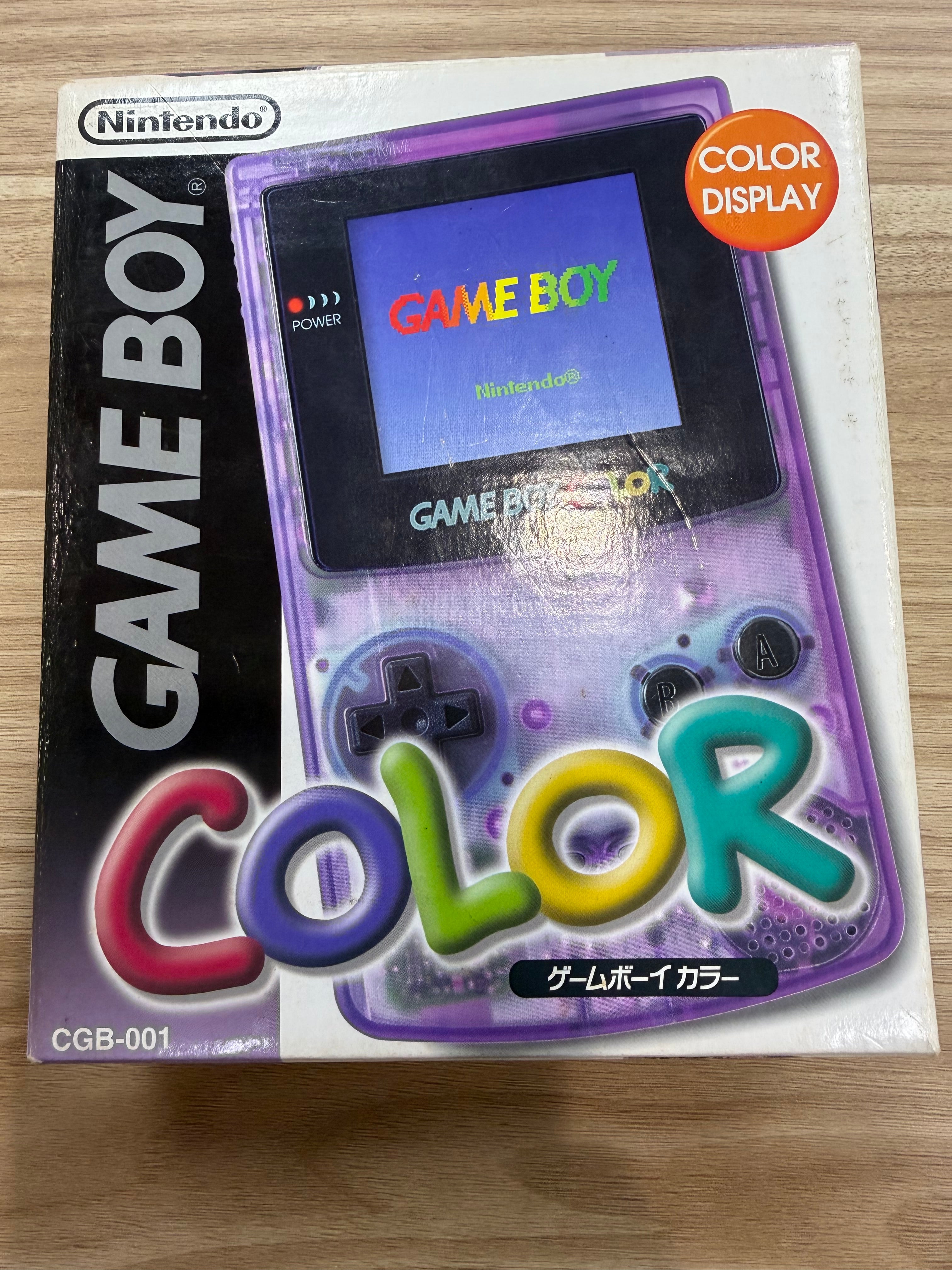 Nintendo Game Boy 'Color' CGB-001 handheld console in its original retail box, featuring a translucent purple body
